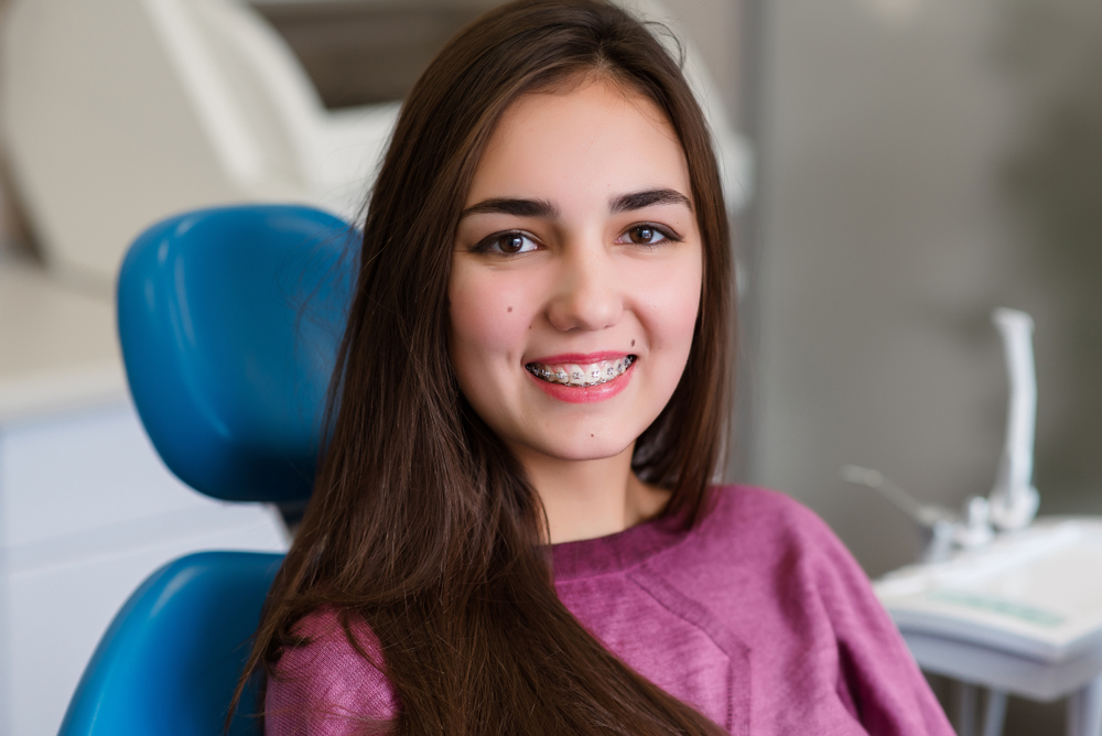 Woman with braces at the dentist - Cosmetic Dentistry Woman with braces at the dentist - Cosmetic Dentistry