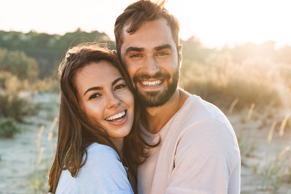 Couple outdoors smiling- Restorative Dentistry Couple outdoors smiling- Restorative Dentistry