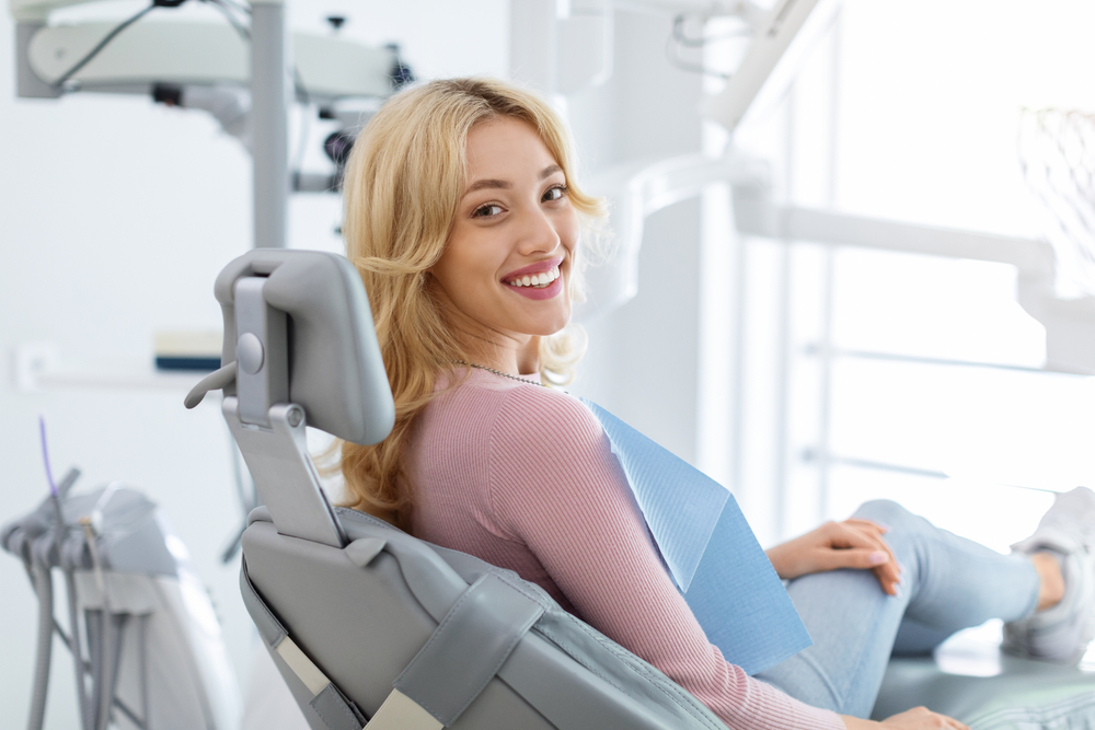 Woman sitting on dental chair - Root Canal Woman sitting on dental chair - Root Canal